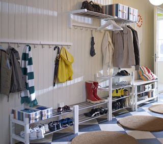 rows of shoe and clothes storage benches in a large hallway