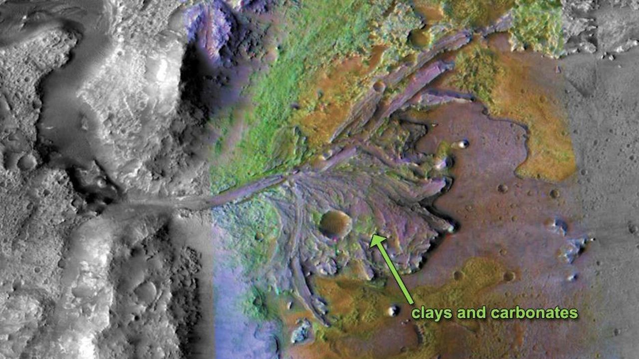 A satellite image of a Martian landscape with a path and fan of sediment cut into the surface