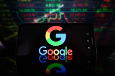 Google logo on smartphone with stock charts in background