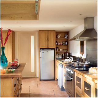 kitchen area with wooden cabinets and worktop