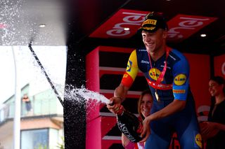 Team Lidl-Trek's Italian rider Jonathan Milan celebrates on the podium after winning the 11th stage of the 107th Giro d'Italia cycling race, 207km between Foiano di Val Fortore and Franca Villa al Mare, on May 15, 2024. (Photo by Luca Bettini / AFP)