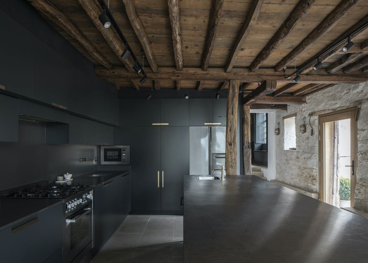 black kitchen in modern extension to cottage