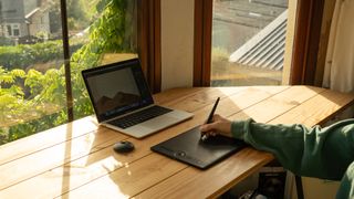 Wacom Intuos Pro Medium being used on a desk by a garden window