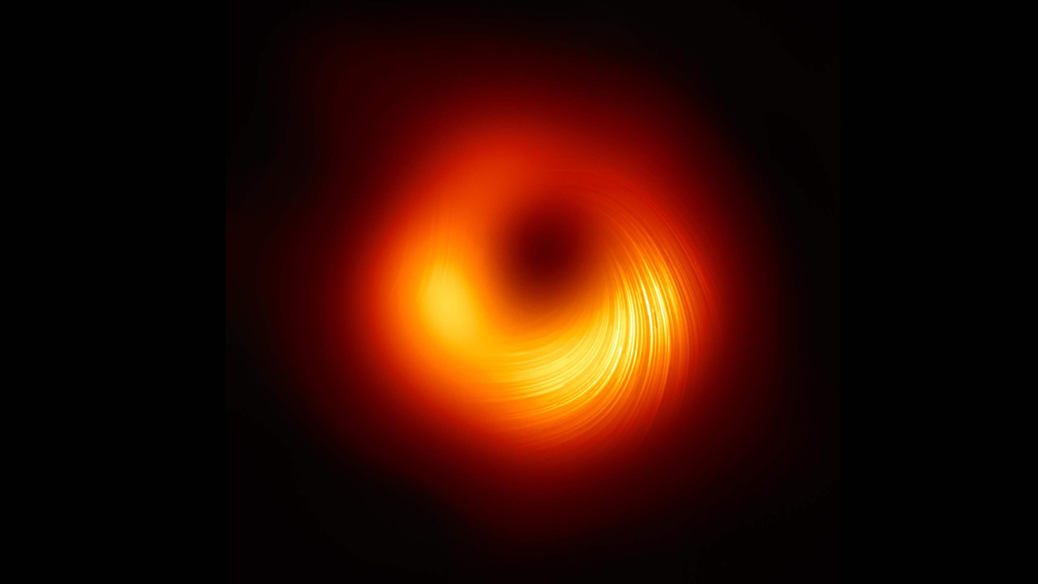 a fuzzy donut shape with a dark center and blurry orange ring.