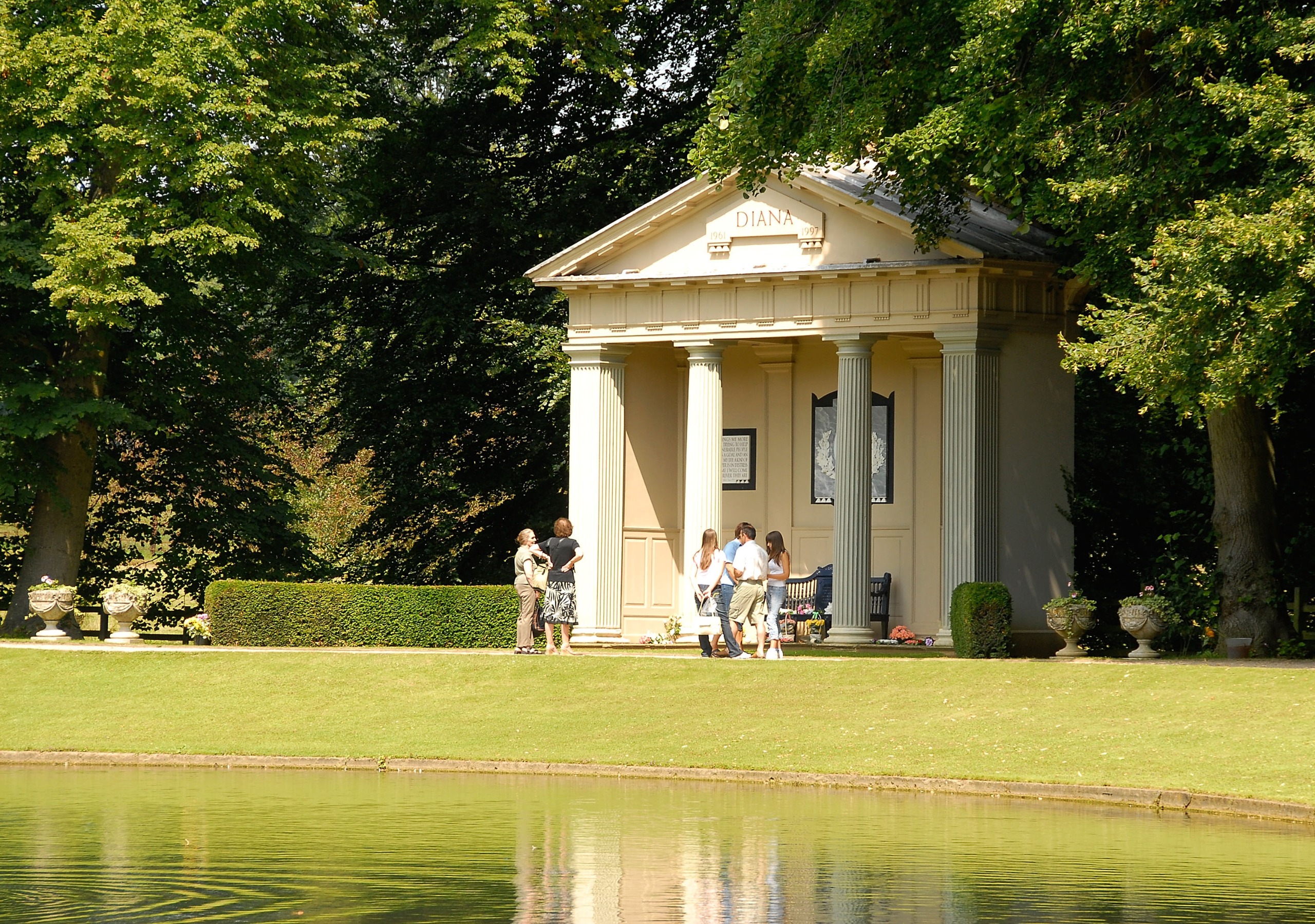 People standing in front of the temple honoring Princess Diana at Althorp