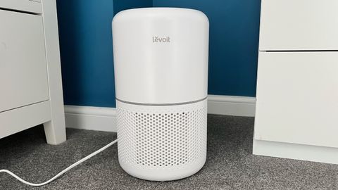 levoit air purifier set up in a bedroom