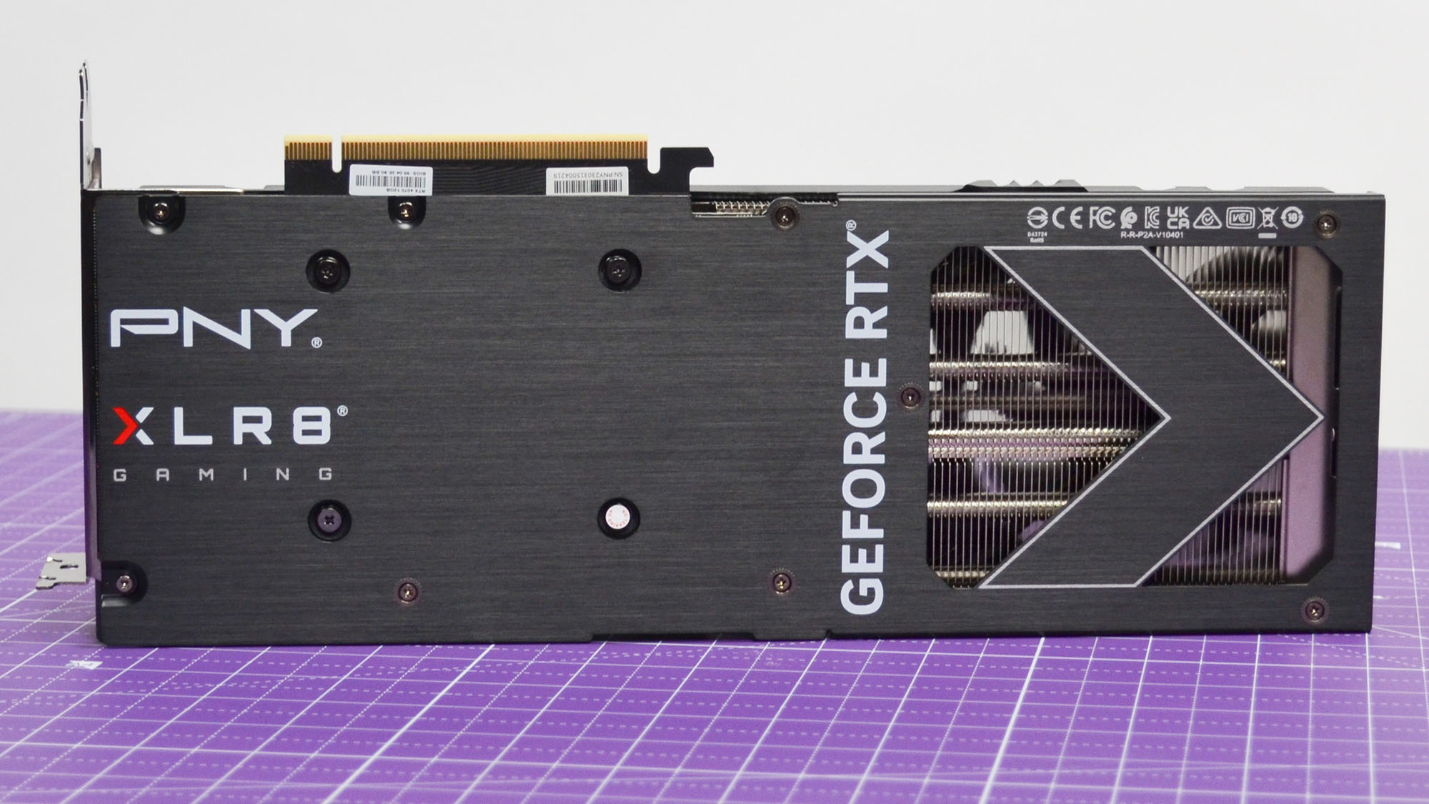 A PNY GeForce RTX 4070 XLR8 OC graphics card on a purple desk mat