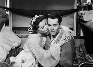 barbara Stanwyck consoles Henry Fonda in a ship bunk in the movie the Lady Eve