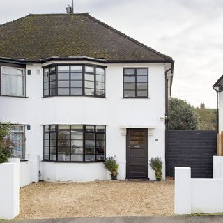 house exterior with white wall and large window
