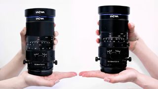 Laowa Tilt Shift lens, being held by a pair of hands against a white background