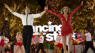 Gleb Savchenko and Jana Kramer with their hands up on Dancing With the Stars.