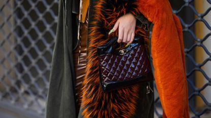 solid perfumes - paris fashion week woman with leather handbag and bright manicure