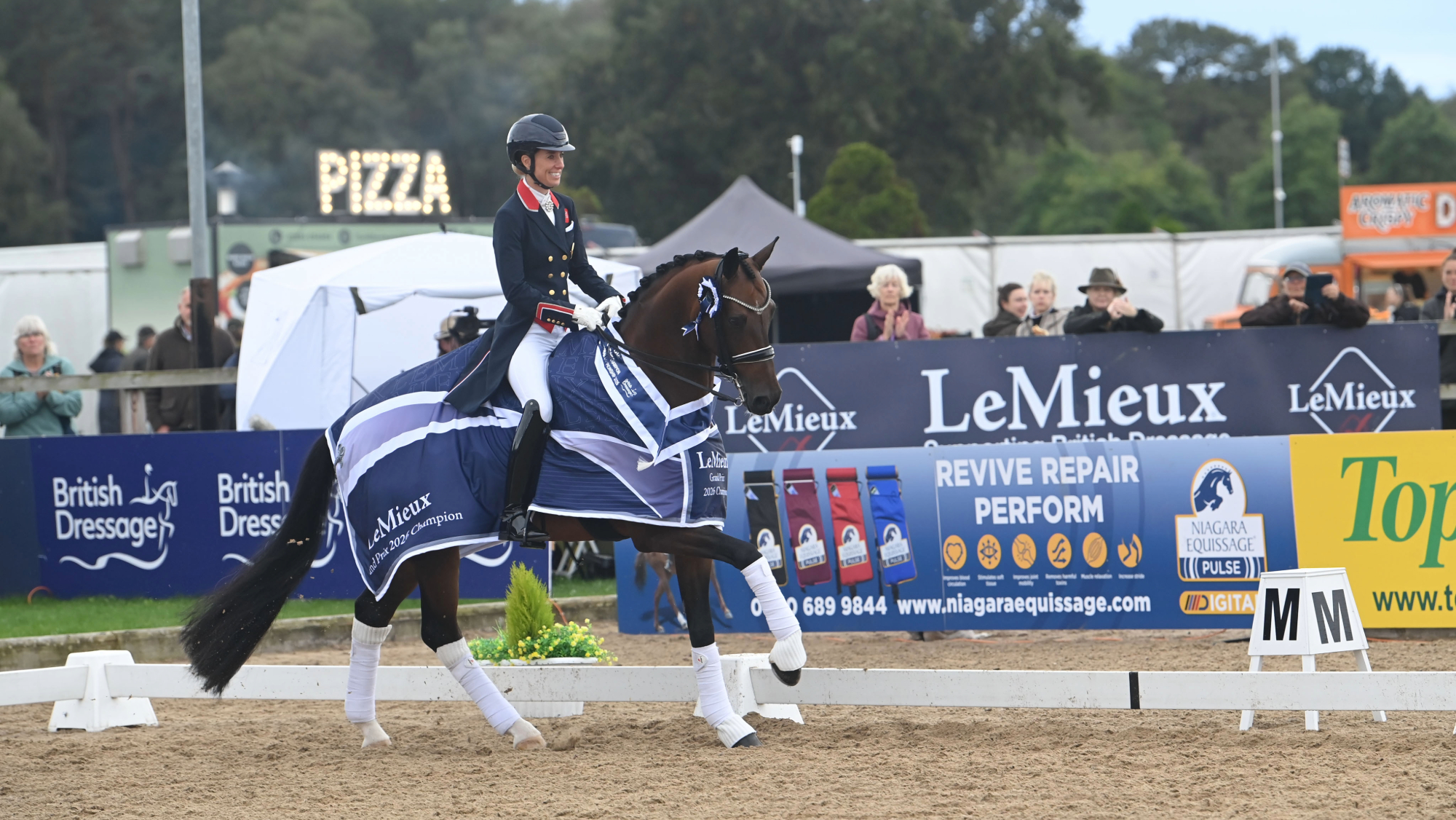 Charlotte Dujardin rides Braveheart II in canter, wearing the LeMieux Grand Prix 2026 Champion rug, after winning the LeMieux grand prix gold championship.