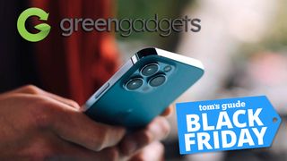 Stock image showing a person holding an iPhone with Green Gadgets logo and Tom&#039;s Guide Black Friday logo overlaid