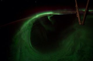 Astronaut Reid Wiseman snapped this image of a loop of green light from an aurora below the International Space Staiton on Aug. 27, 2014.