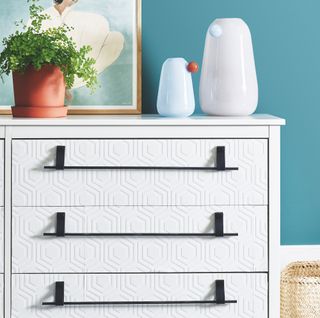 white vanity with potted plant and peacock green wall colour