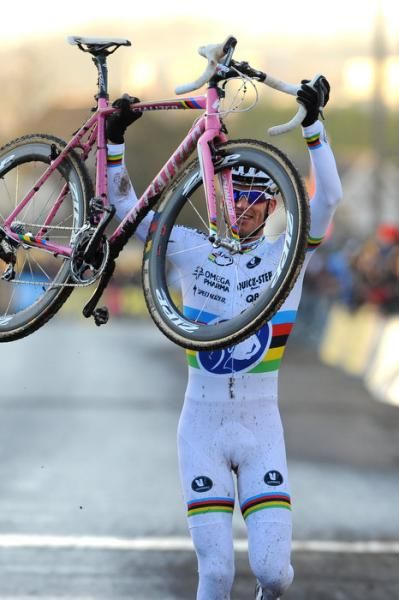 Elite men's winner Zdenek Stybar hoists his Specialized bike aloft at the finish.