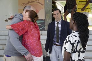 At Saint Marie airport, Melanie (Doon Mackichan) engulfs an unprepared Dave (Youssef Kerkour) in a hug. Neville (Ralf Little), who is carrying her bags, looks on warily, while Naomi (Shantol Jackson) watches too, with her back to the camera