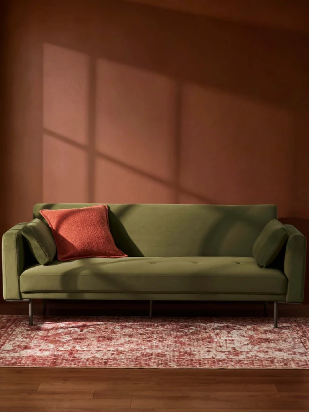 A three-seater green sofa bed from DUSK
