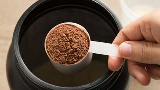 Scoop of brown protein powder