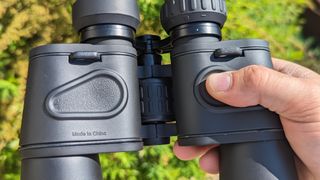 Thumb grips shown on the bottom of the binoculars