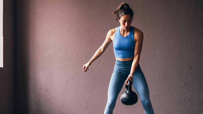 a photo of a woman holding a kettlebell