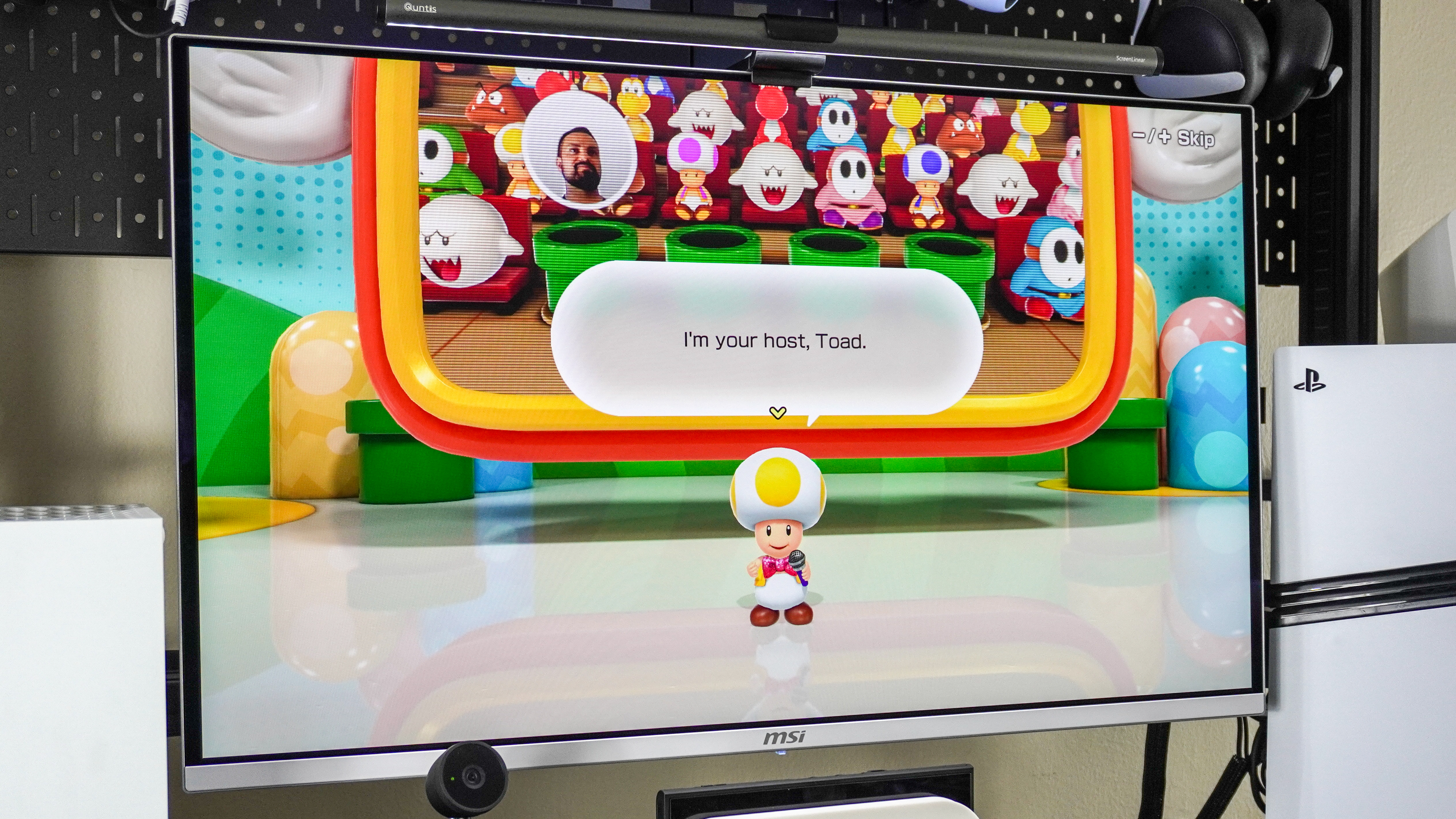 A picture of Super Mario Party Jamboree + Jamboree TV being played on a monitor with a live video feed of a player as their avatar