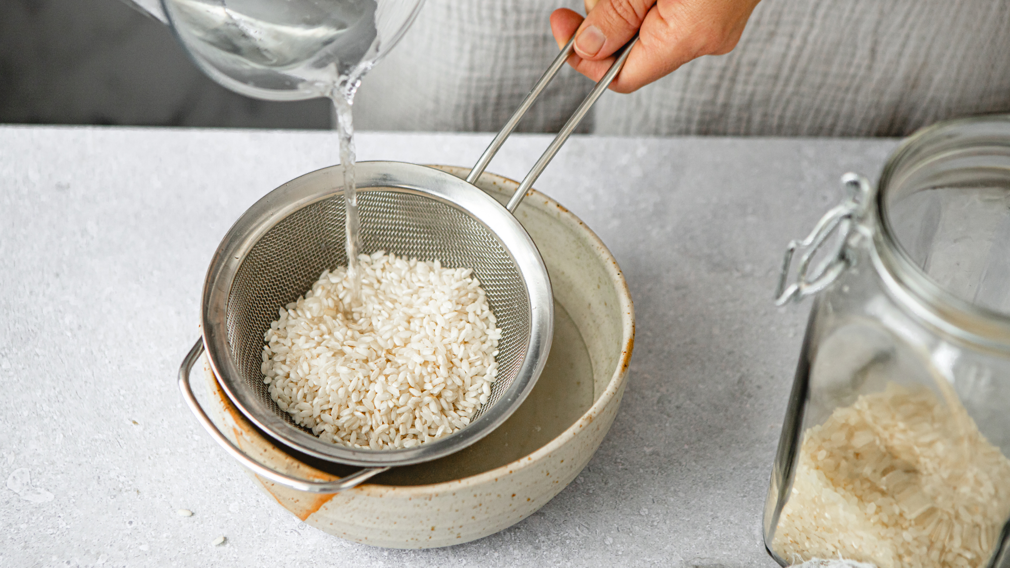 Woman pouring water over rice