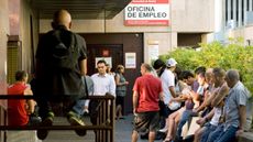 Unemployed workers wait outside a government job centre in Madrid July 29, 2011. Spain's battered economy suffered more bad news as Moody's threatened to downgrade the country's rating and th