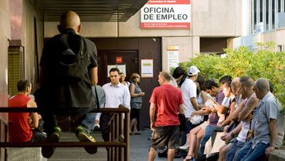 Unemployed workers wait outside a government job centre in Madrid July 29, 2011. Spain's battered economy suffered more bad news as Moody's threatened to downgrade the country's rating and th