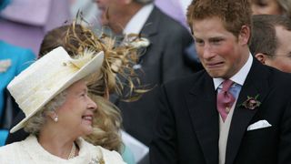 Queen Elizabeth II and Prince Harry share a joke as they watch Prince Charles and his bride Camilla Duchess of Cornwall leave St George's Chapel in Windsor following their marriage blessing, 09 April 2005. Prince Charles and his longtime sweetheart Camilla Parker Bowles married today after two months of muddled preparations and a lifetime of waiting. (Photo by ALASTAIR GRANT / POOL / AFP)