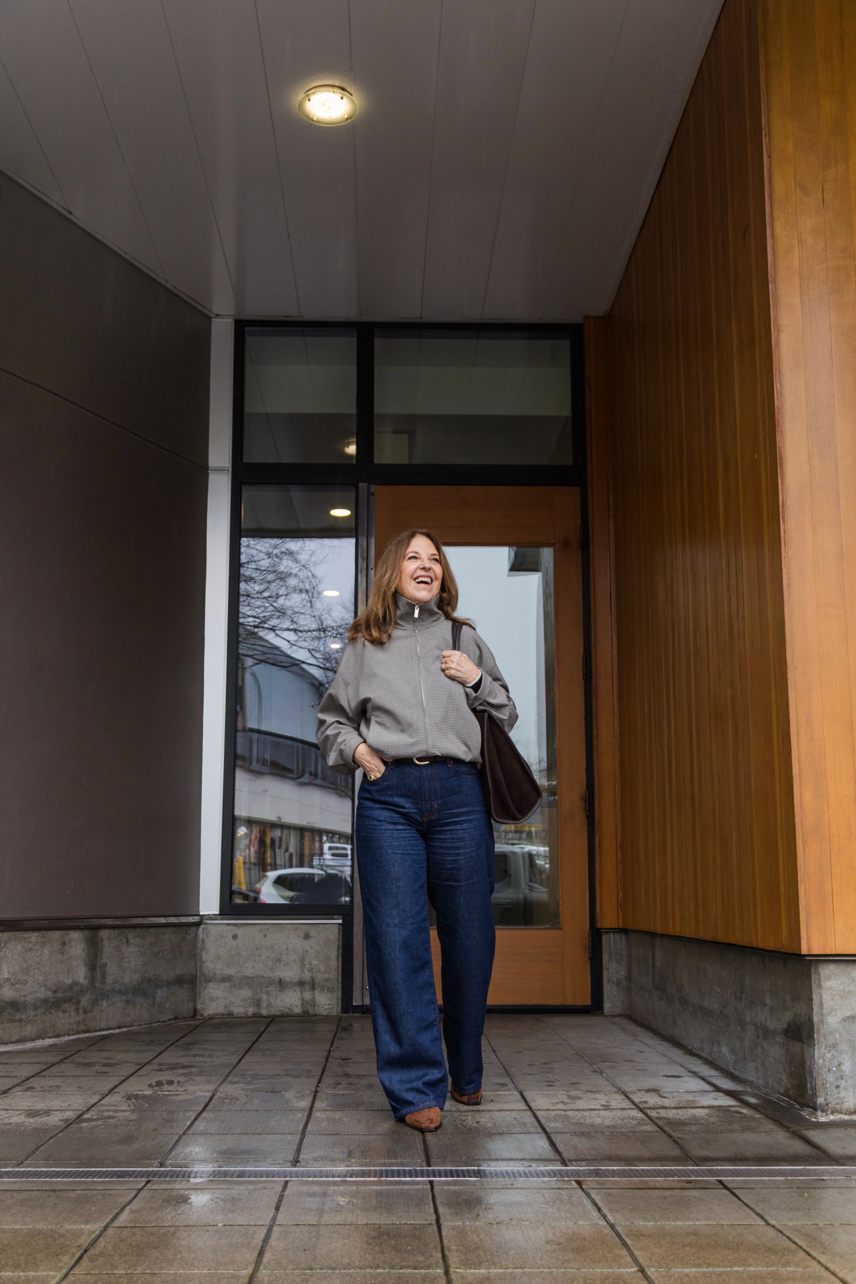 Sandy Koszarek wearing a track jacket and dark-wash jeans.