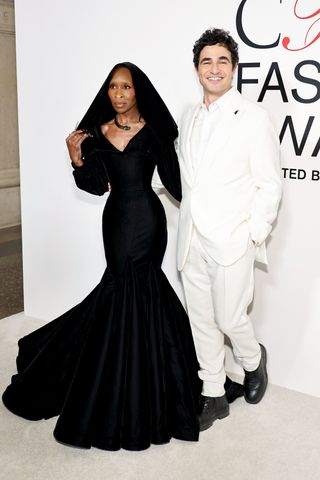 A photo of Cynthia Erivo in a black hooded gown designed by Zac Posen