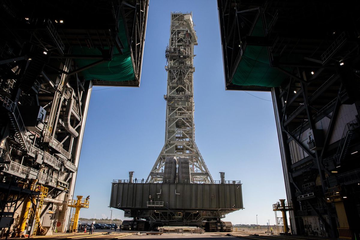 A view from inside the Vehicle Assembly Building at NASA&#039;s Kennedy Space Center in Florida on Dec. 9, 2022, as the mobile launcher approaches, carried atop the crawler-transporter 2 vehicle..