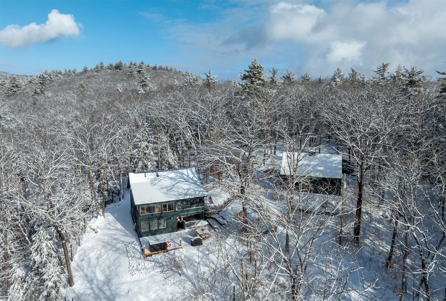 An aerial view of a home in the snow
