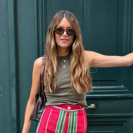 Woman wearing striped jeans, a breakout summer 2026 trend.