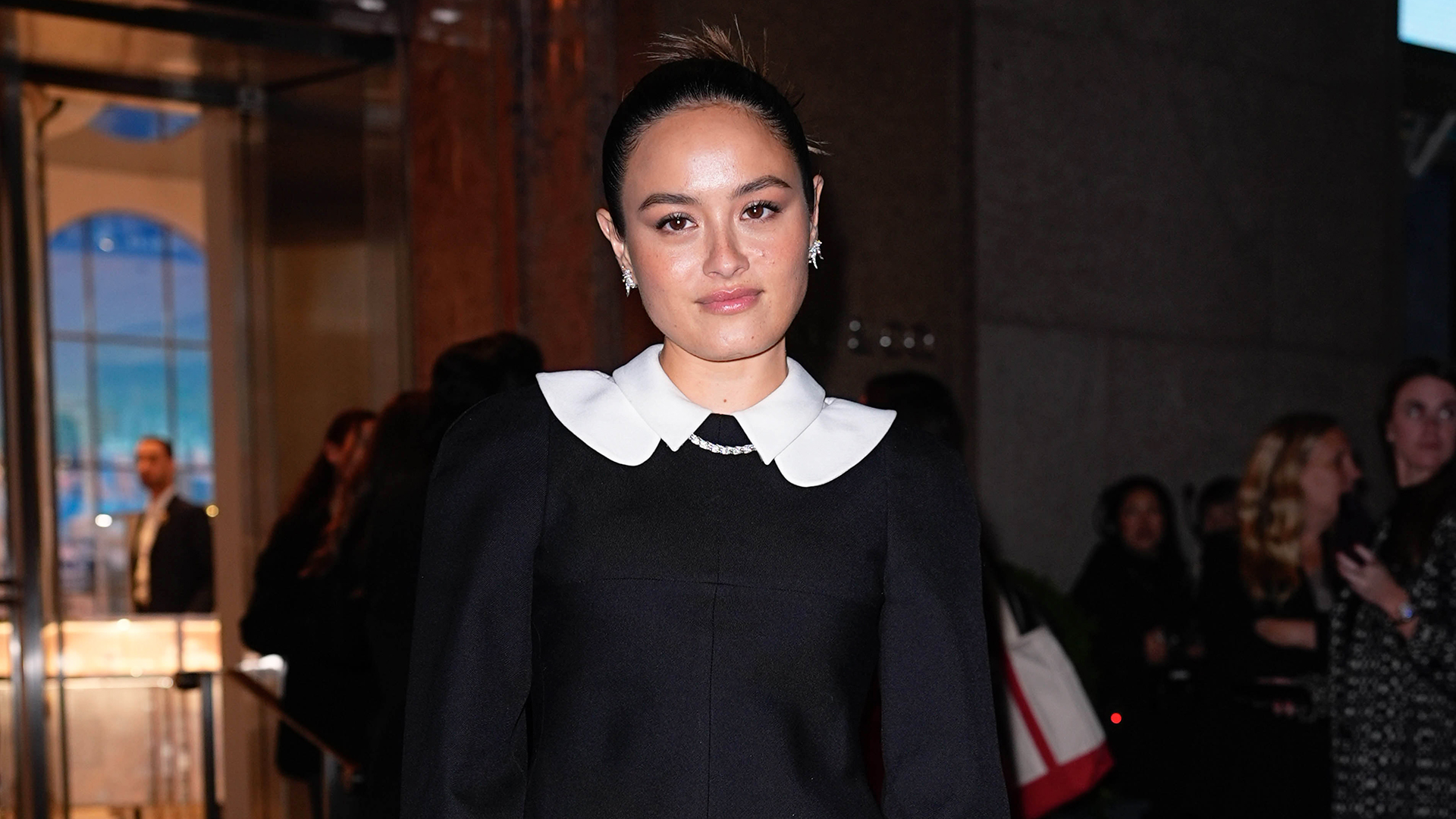 Chase Sui Wonders wearing a white-collar black jacket with a miniskirt