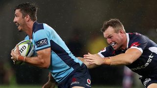 Jake Gordon of the Waratahs is tackled during the round 3 Super Rugby match between the Rebels and the Waratahs