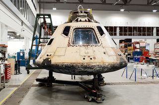 The Skylab 4 command module atop its new mounting base in the restoration hangar at the National Air and Space Museum's Steven F. Udvar-Hazy Center in Chantilly, Virginia.