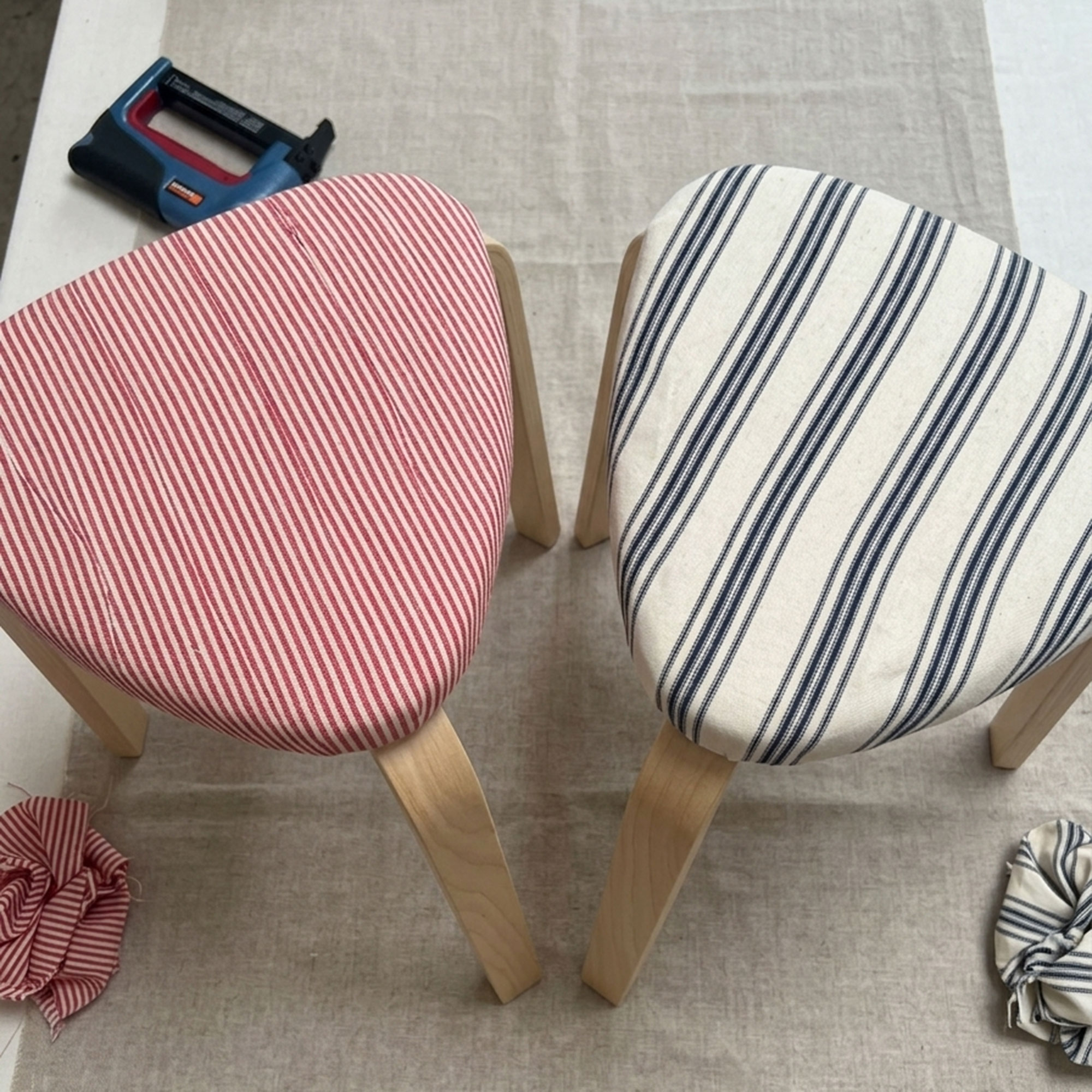 AI image of two stools upholstered with striped fabric