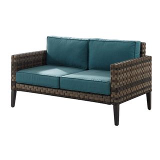 Wicker outdoor loveseat with a blue cushion