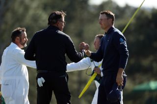 Spieth shakes hands with Mickelson on the 18th green