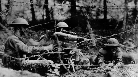 WWI soldiers behind a barbed wire