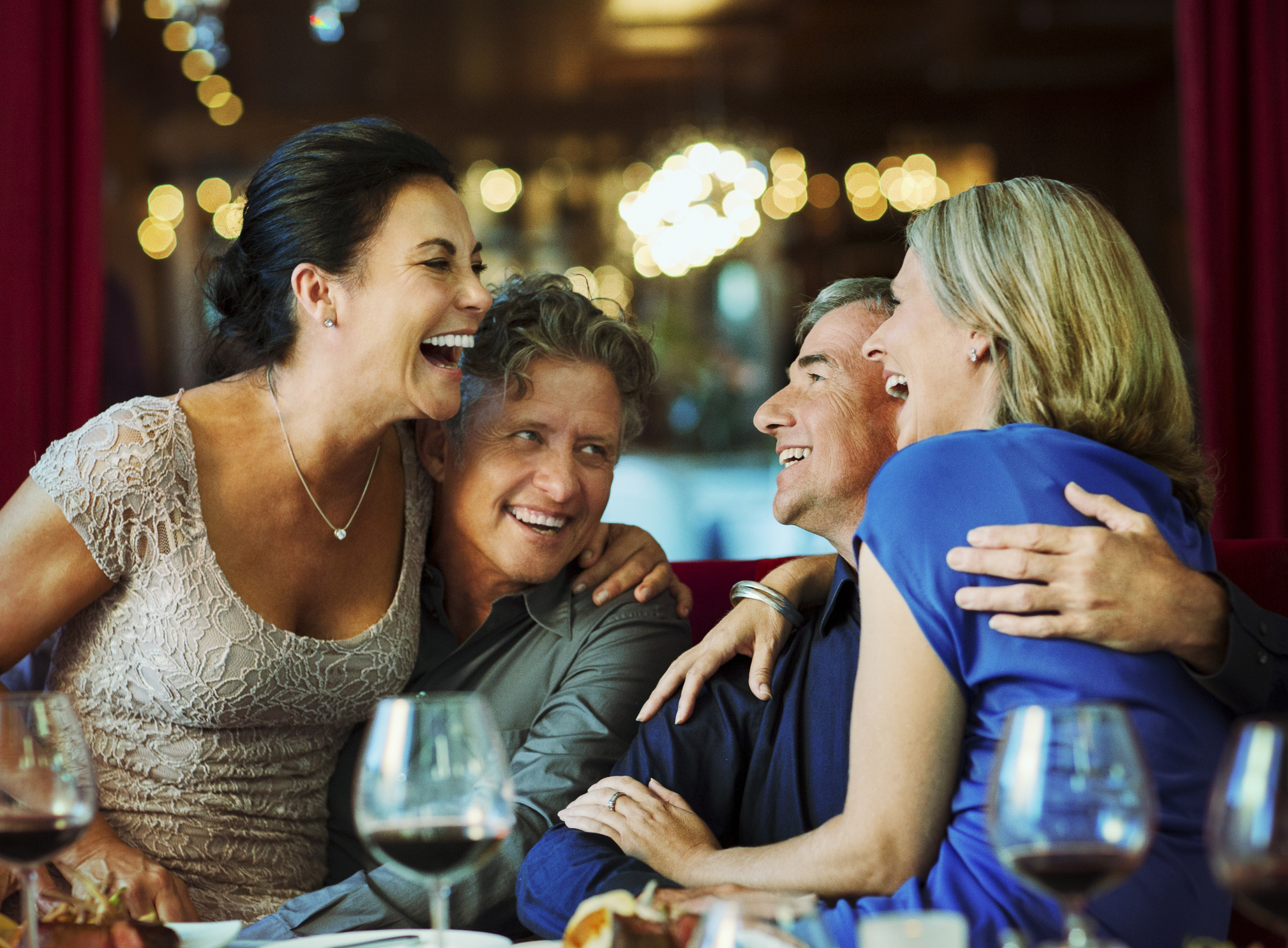 Two older couples at a bar.