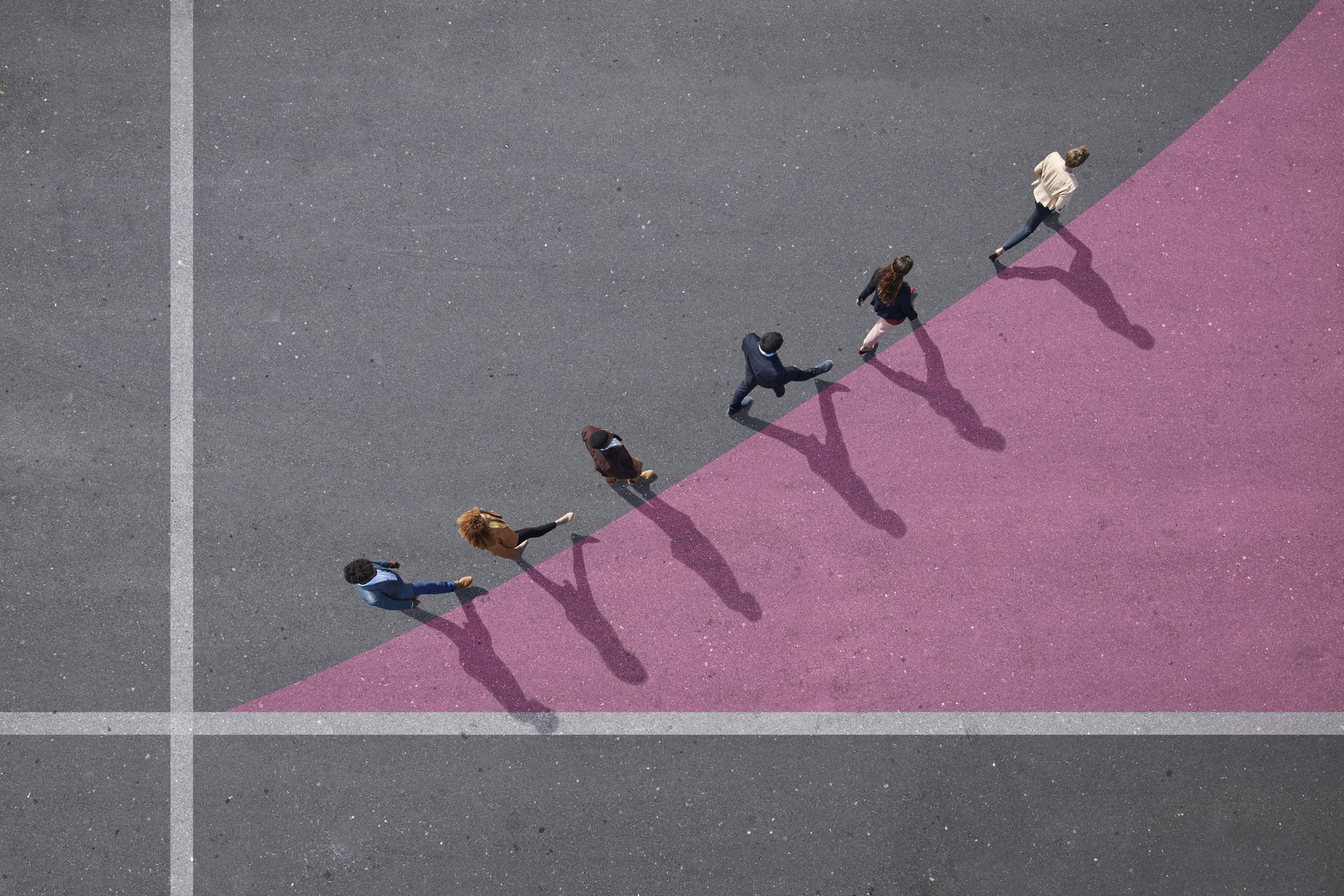 six people walking in single file along the top line of a pink chalked triangle