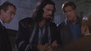 John Hannah Oded Fehr and Brendan Fraser stand looking concerned in front of Freddie Boath in The Mummy Returns.