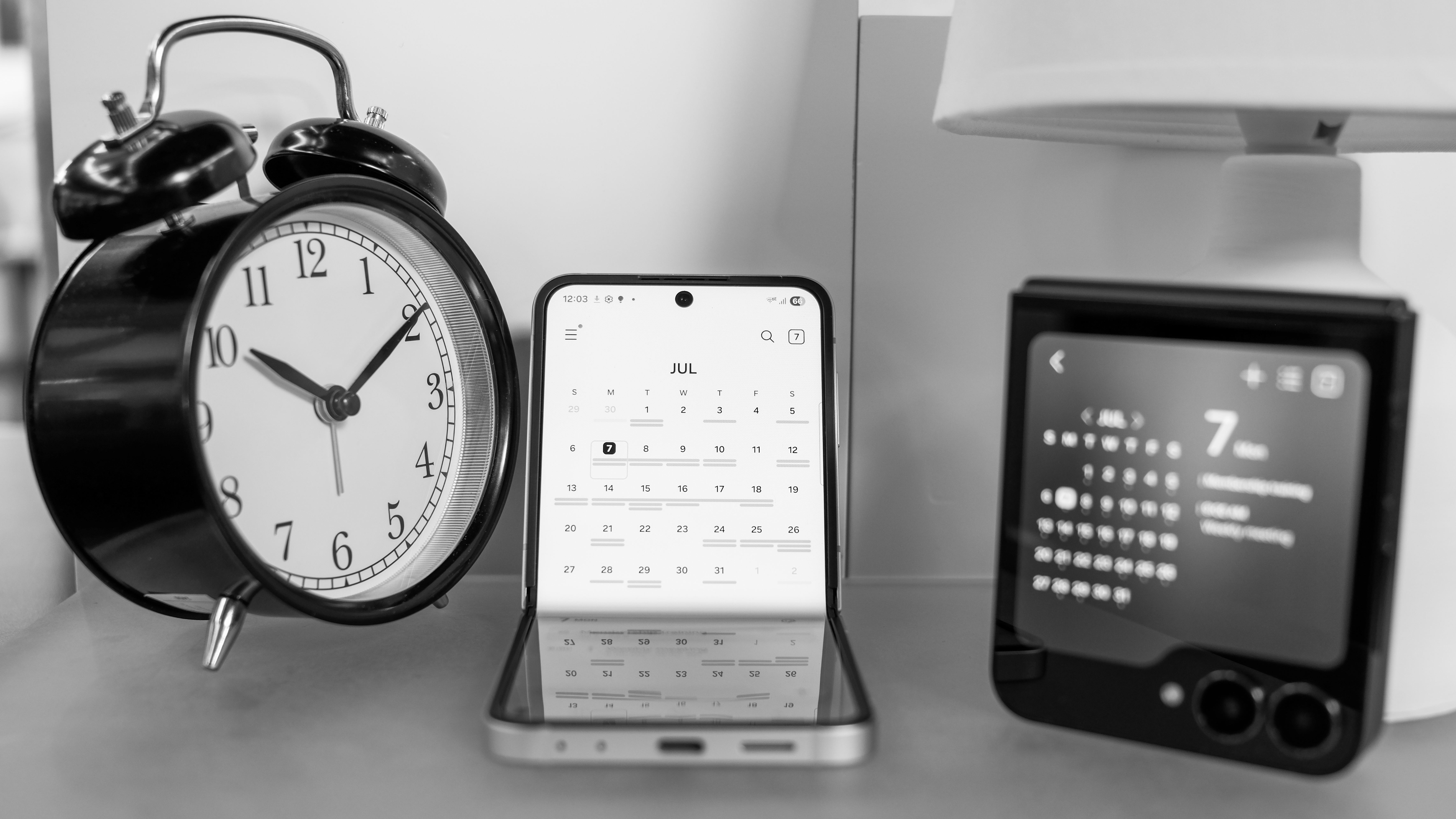 Two Samsung Galaxy Z Flip 7 FE devices one partially closed one fully closed both showing the Calendar app