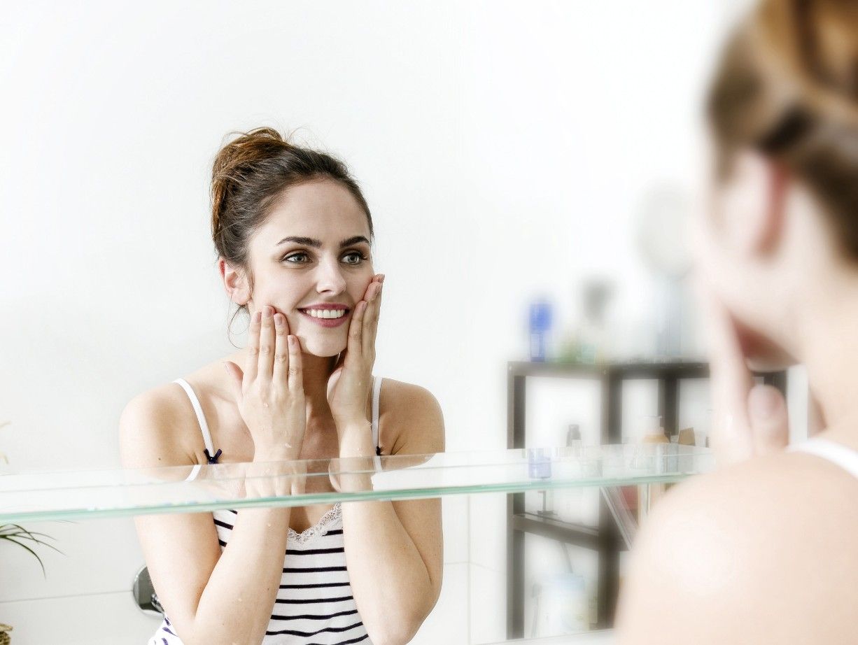 Woman washing her face