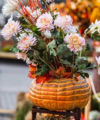 carved pumpkin vase with flowers