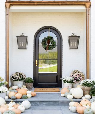 Fall porch decorated with pumpkins, wreath